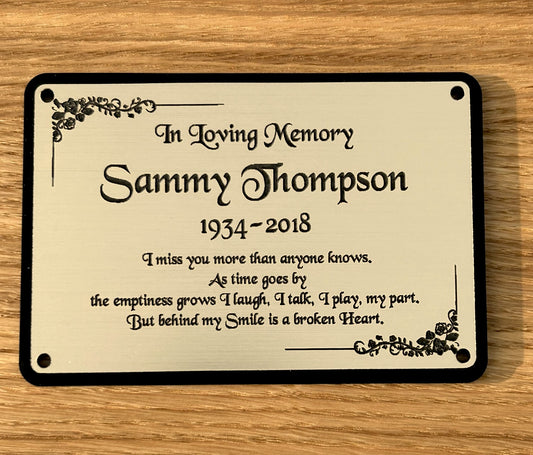 A personalized memorial bench plaque with gold and black colours, featuring an engraved message and the name 'Sammy Thompson'.