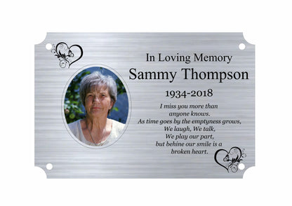 Memorial plaque with a photo of a woman and text in loving memory on a white background